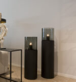 Two black candle holders with glass