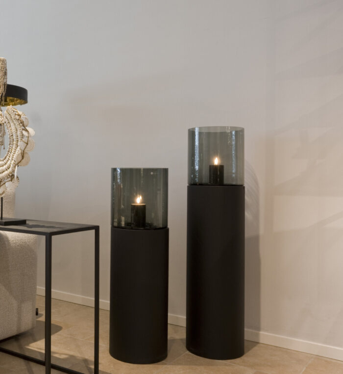 Two black candle holders with glass
