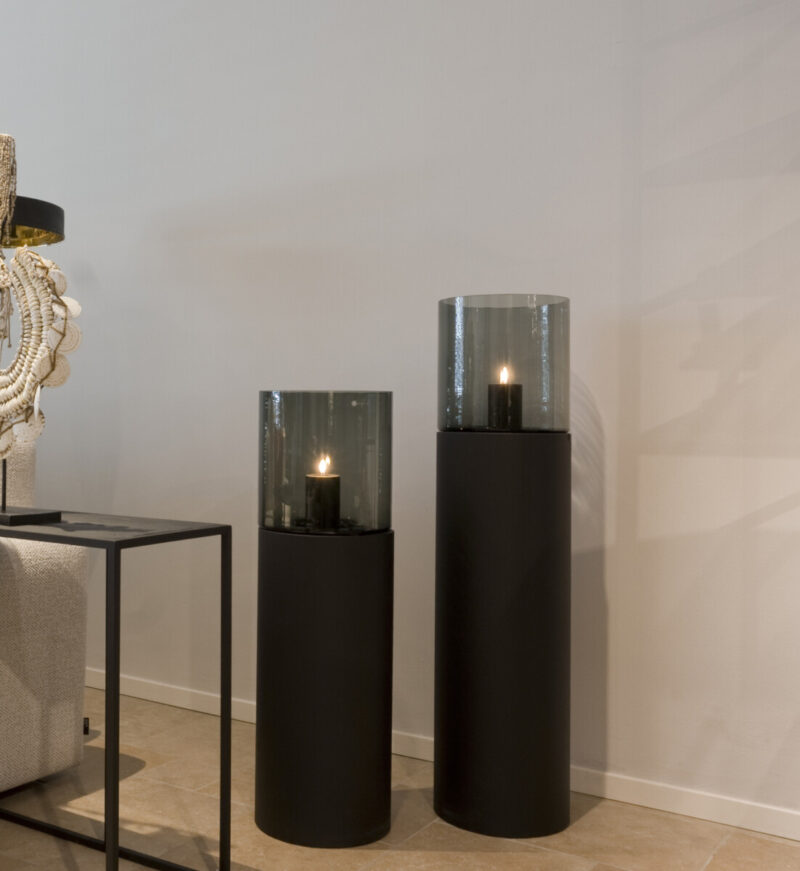 Two black candle holders with glass