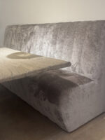 Grey sofa with wooden table.