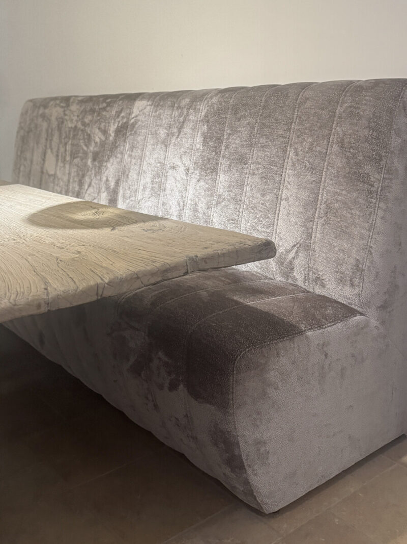 Grey sofa with wooden table.