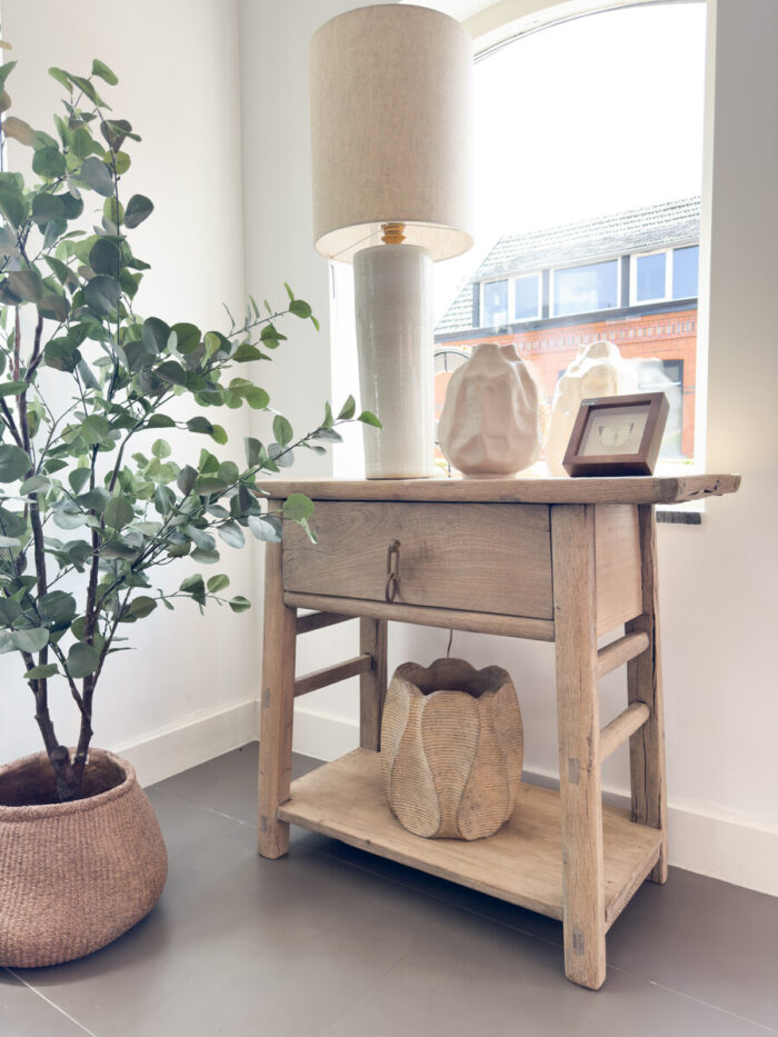 Wooden table with lamp and plants