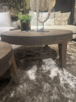 Round wooden table on a rug