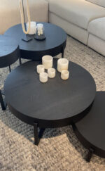 Black coffee tables with candles.