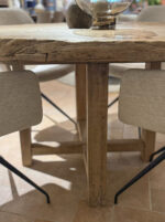 Wooden table with chairs around it