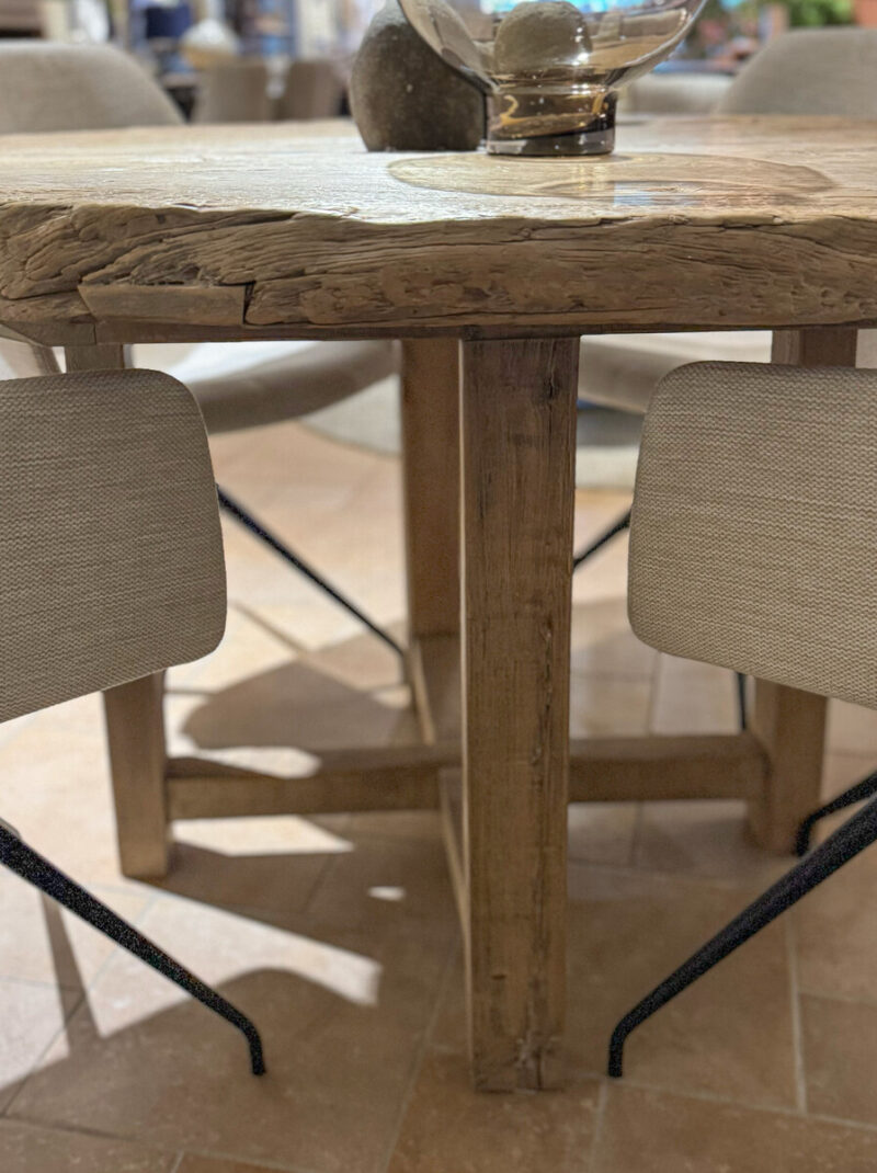 Wooden table with chairs around it