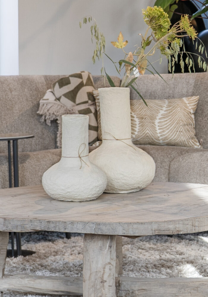 Two vases on a wooden table