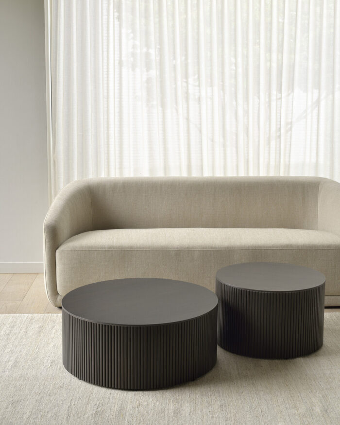 Modern sofa with round tables.