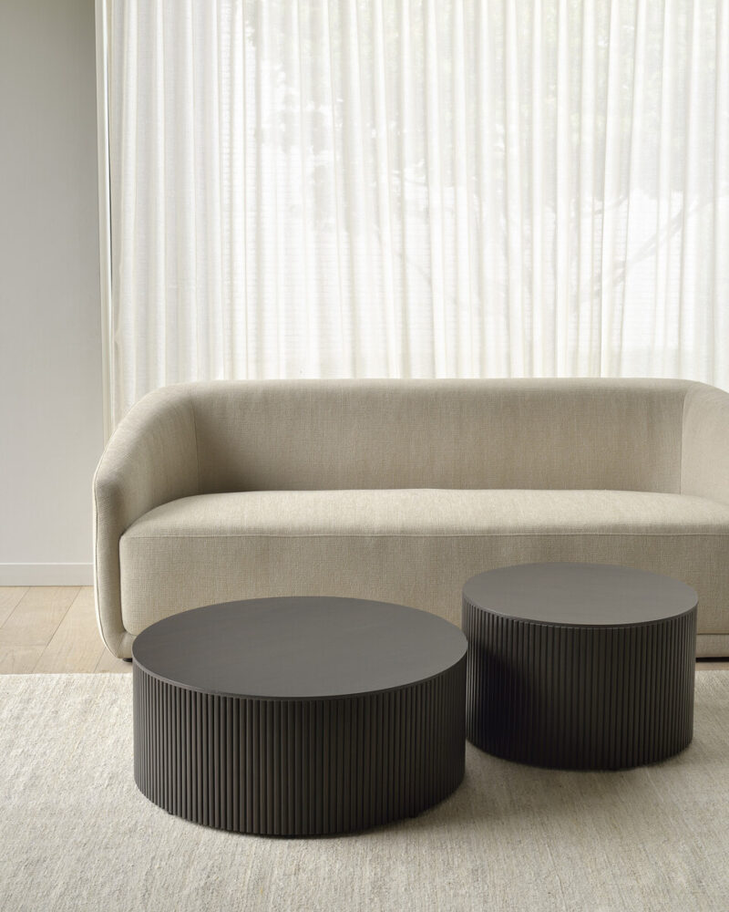 Modern sofa with round tables.
