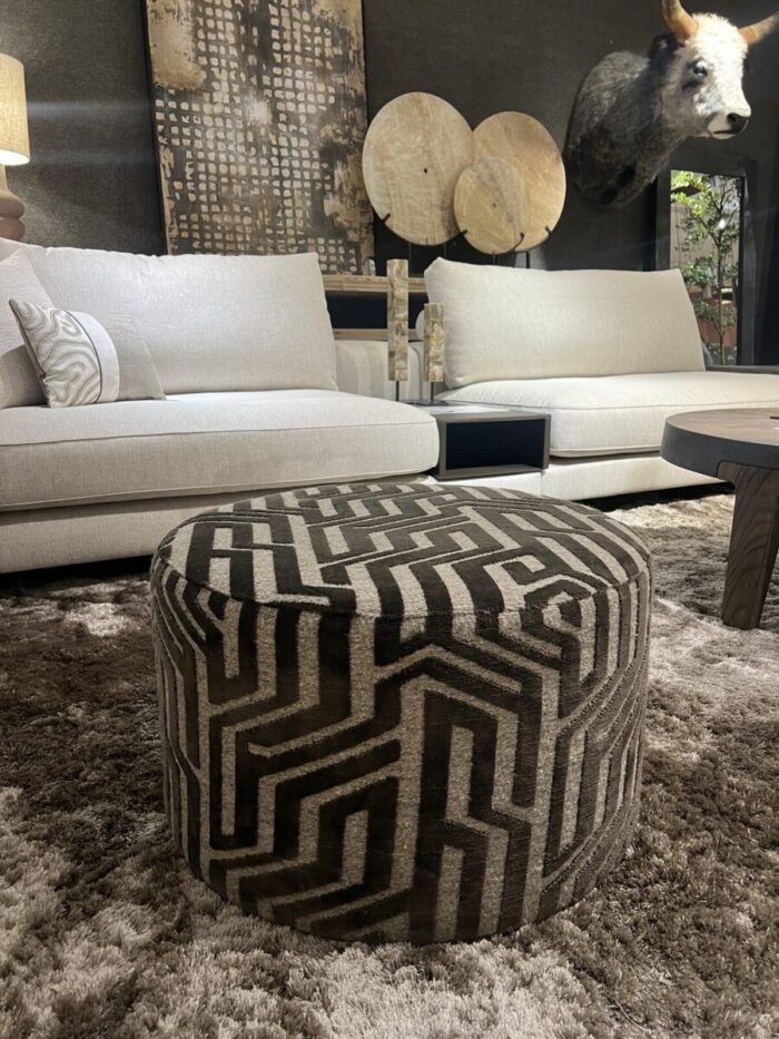 Modern living room with a striped pouffe