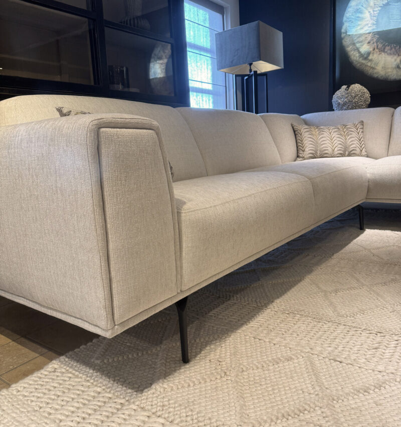Modern, light-coloured sofa on a rug