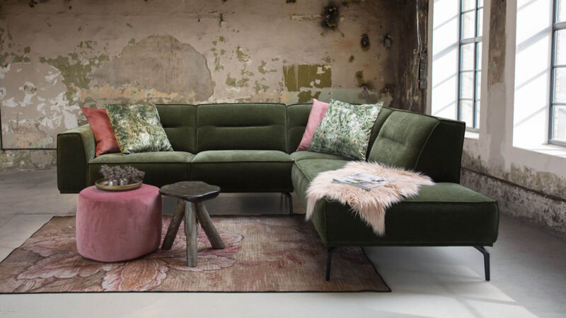 Green sofa in an industrial interior