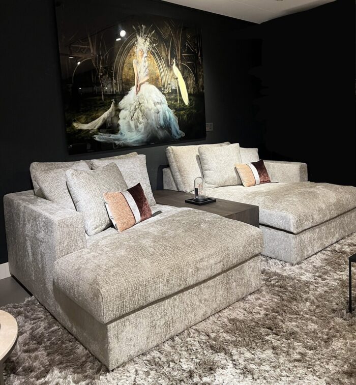 Two comfortable sofas with cushions.