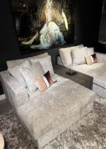 Two comfortable sofas with cushions.