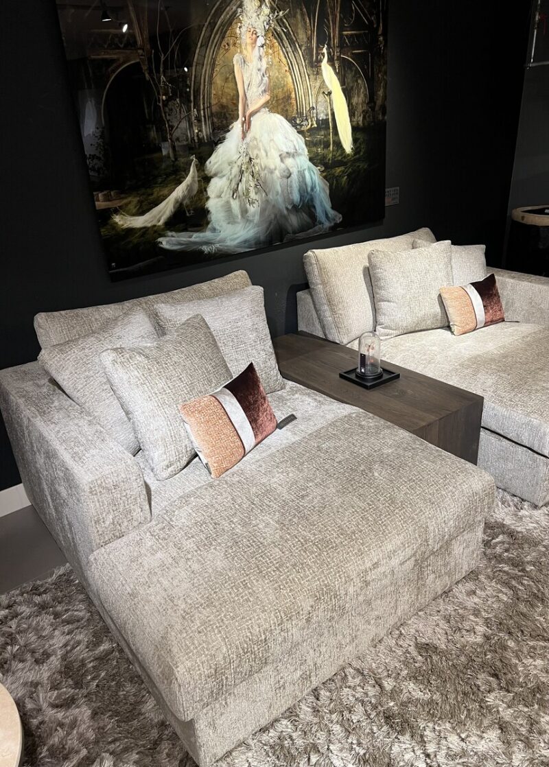 Two comfortable sofas with cushions.