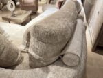 Soft, beige sofa with cushions.