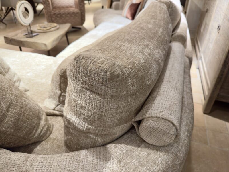 Soft, beige sofa with cushions.