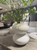 White vase with branches and flowers
