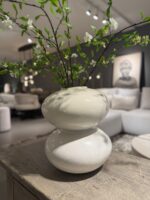 White vase with branches and flowers