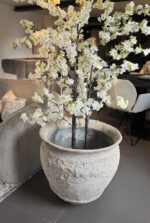 Vase with artificial flowers in living room