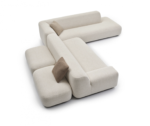 Modern, light corner sofa with cushions