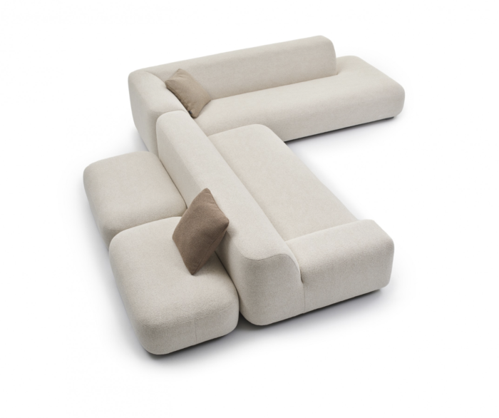 Modern, light corner sofa with cushions